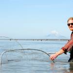 Stephen Lynch of Nikiski dipnets on the north beach in Kenai, Alaska on Sunday, July 23. (Photo by Kat Sorensen/Peninsula Clarion)