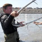 Zachary Murphy of Palmer struggles to bring in a sockeye salmon while dipnetting on the north beach of Kenai, Alaska on July 23, 2017. The fish got away. (Photo by Kat Sorensen/Peninsula Clarion)
