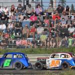 A full crowd watches as Legends drivers Brent Ramagoux (6) and Bryan Barber race for position during the running of the Alaska Dirt Track Shootout held Saturday at Twin City Raceway in Kenai. (Photo by Joey Klecka/Peninsula Clarion)