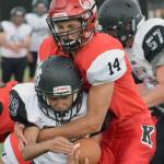 Kenai Central&rsquo;s Logan Baker stuffs Nikiski&rsquo;s Jim Lamping for a loss Friday, July 11, 2017, during a scrimmage at Ed Hollier Field in Kenai. (Photo by Jeff Helminiak/Peninsula Clarion)