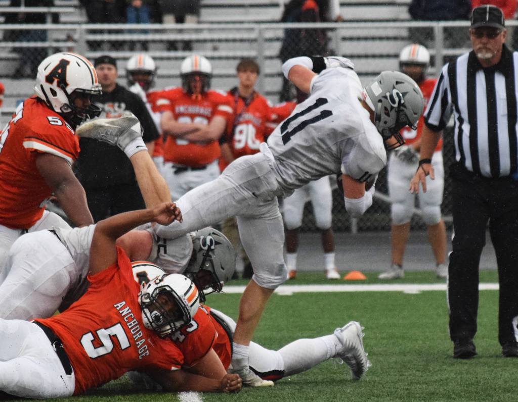 Soldotna senior Brenner Furlong breaks free of a cluster of West defenders Friday at West Anchorage High School. (Photo by Joey Klecka/Peninsula Clarion)