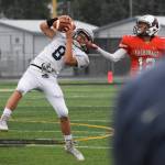 Soldotna&rsquo;s Cy Updike hauls in an interception in front of West receiver A.J. Su&rsquo;esu&rsquo;e Friday at West Anchorage High School. (Photo by Joey Klecka/Peninsula Clarion)