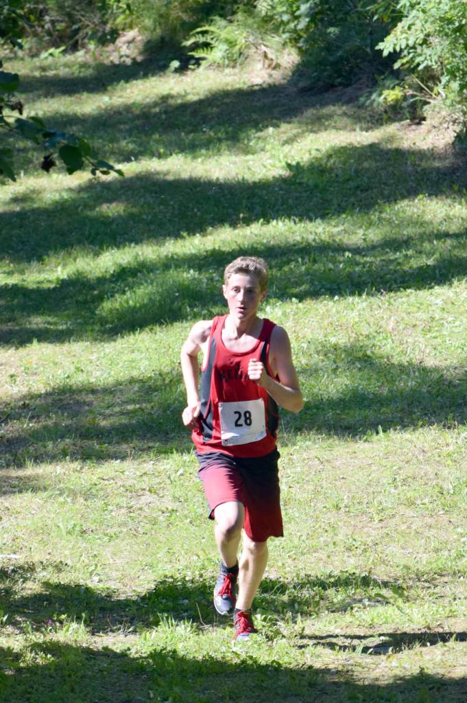 Kenai Central freshman Maison Dunham runs to victory in the freshmen-sophomore boys race Monday, Aug. 14, 2017, at the Nikiski Class Races at Nikiski High School. (Photo by Jeff Helminiak/Peninsula Clarion)