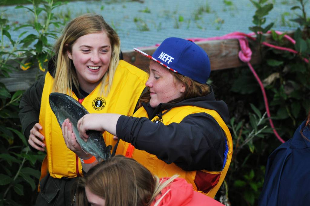 A participant in the Kenai River Junior Classic holds up a salmon she caught Wednesday, Aug. 16, 2017 near Soldotna, Alaska. The event, organized by Soldotna-based sportfishing organization the Kenai River Sportfishing Association, brings kids from all over Southcentral Alaska to learn about fishing and boating safety followed by a fishing trip with professional guides on the Kenai River. (Photo by Elizabeth Earl/Peninsula Clarion)