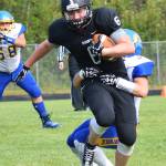 Nikiski junior Cody Handley escapes the grasp of a Monroe Catholic tackler Saturday at Nikiski High School. (Photo by Joey Klecka/Peninsula Clarion)