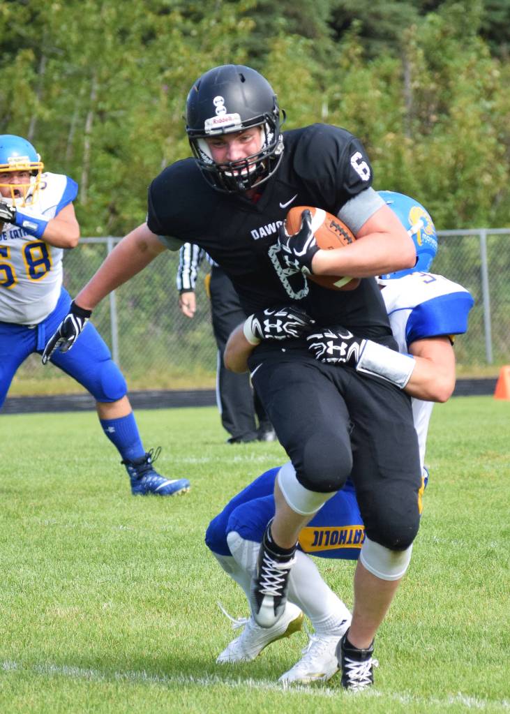 Nikiski junior Cody Handley escapes the grasp of a Monroe Catholic tackler Saturday at Nikiski High School. (Photo by Joey Klecka/Peninsula Clarion)