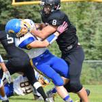 Nikiski senior Ian Johnson (8) sheds Monroe Catholic defensive back Parker Glaves in the third quarter of Saturday&rsquo;s Division III game at Nikiski High School. (Photo by Joey Klecka/Peninsula Clarion)