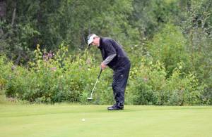 Chris Morin putts for birdie on the 18th green Sunday, Aug. 20, 2017, at the Kenai Golf Course during the Kenai Open. Morin&rsquo;s putt came up short and the three-time defending champ lost by one stroke to Max Dye. (Photo by Jeff Helminiak/Peninsula Clarion)