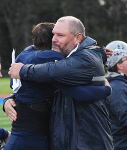 Soldotna head football coach Galen Brantley Jr. hugs senior quarterback Brandon Crowder after Friday night&rsquo;s 52-7 win over South Anchorage at Justin Maile Field in Soldotna. The win was the 100th in Brantley Jr.&rsquo;s coaching career. (Photo by Joey Klecka/Peninsula Clarion)