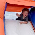 Three-year-old Trey Dodge plays in a bounce castle during Industry Appreciation Day on Saturday, Aug. 26, 2017 in Kenai, Alaska. (Photo by Kat Sorensen/Peninsula Clarion)