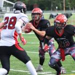 Kenai Central quarterback Connor Felchle looks for an open receiver against Juneau while teammate Rykker Riddall (28) puts up a block Saturday afternoon at Ed Hollier Field in Kenai. (Photo by Joey Klecka/Peninsula Clarion)