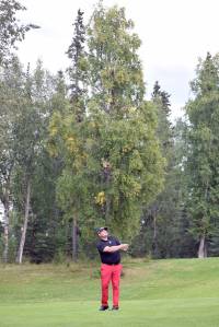 Birch Ridge assistant pro Beau Forrest hits an approach shot to No. 18 during a playoff at the Kenai Peninsula Open at Birch Ridge Golf Course on Sunday, Aug. 27, 2017. (Photo by Jeff Helminiak/Peninsula Clarion)