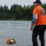 Paul Montenieri, the founder of the Soldotna senior softball league, releases a wreath in honor of Kurt Keltner on the Kenai River on Tuesday, Aug. 29, 2017 in Soldotna, Alaska. Keltner, who lived in Sterling during the summers and Colorado in the winters, has been missing since Aug. 4, when he was thrown from a fishing boat due to a mechanical error near Centennial Park and was not able to swim to shore. (Photo by Elizabeth Earl/Peninsula Clarion)