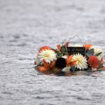 A wreath honoring Kurt Keltner, who is still missing after falling in the Kenai River on Aug. 4, floats downstream near Centennial Park on Tuesday, Aug. 29, 2017 in Soldotna, Alaska. The Soldotna senior softball league, of which Keltner was a member, laid the wreath on the water Tuesday after concluding its season. (Photo by Elizabeth Earl/Peninsula Clarion)