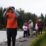 Members of the Soldotna senior softball league watch as a wreath honoring teammate Kurt Keltner, who is still missing after falling in the Kenai River on Aug. 4, floats downstream from Centennial Park on Tuesday, Aug. 29, 2017 in Soldotna, Alaska. (Photo by Elizabeth Earl/Peninsula Clarion)