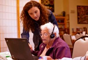 Putting technology to work Mariana Livingston (standing) of Assistive Technology of Alaska guides Brad Rooker through demonstrations of a hearing device and software that enlarges and enhances the contrast of digital text for the visually impaired on Wednesday at the Kenai Senior Center. Livingston&rsquo;s Anchorage-based group was one of four at the senior center to hold a health fair and one-on-one clinics for those interested in aid devices for vision, hearing, and mobility. Others included the Independent Living Center, the Alaska Center for the Blind, and the Kenai Centenial Savvy Lions Club, which offered free vision exams. Independent Living Center office manager Melissa Kline said the groups hope to hold the event annually in Kenai in the fall and at the Soldotna Senior Center in the spring. (Ben Boettger/Peninsula Clarion)