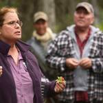 Leading a group of berry seekers, Janice Chumley of the University of Alaska Fairbanks Cooperative Extension Service contrasts the tasty lingonberry (also known as lowbush cranberries) with the &ldquo;edible but insipid&rdquo; specimen of bunchberry dogwood in her right hand during an instructional walk on Monday, August 28, 2017 at Tsalteshi Trails near Soldotna, Alaska. The event was part of the fifth annual Harvest Moon Local Food Festival, which concluded Monday.