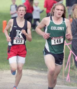 Colony&rsquo;s Gavin Block runs just ahead of Kenai Central&rsquo;s Maison Dunham during the boys varsity race of the Palmer Invitational on Saturday, Sept. 2, 2017, at Palmer High School. Dunham finished seventh and Block was 10th. (Photo by Jeremiah Bartz/Frontiersman)