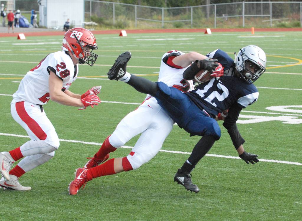 Eagle River&rsquo;s Justice Townsend is tackled by Kenai&rsquo;s Titus Riddall during Kenai&rsquo;s 42-28 Northern Lights Conference football win over the Wolves on Saturday, Sept. 2, 2017 at Eagle River High School. (Star photo by Matt Tunseth)