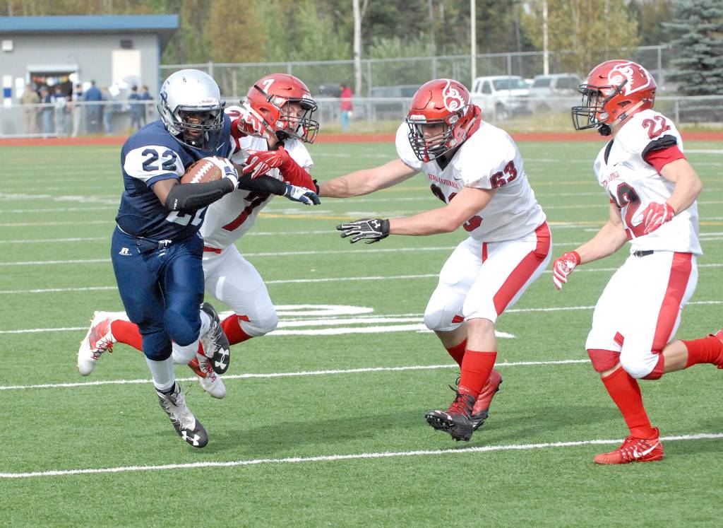Eagle River&rsquo;s Kam Williams is corralled by Kenai&rsquo;s Jakob O&rsquo;Brien (7), Seth Kruse (63) and Titus Riddall (22) during Kenai&rsquo;s 42-28 Northern Lights Conference football win over the Wolves on Saturday, Sept. 2, 2017 at Eagle River High School. (Star photo by Matt Tunseth)