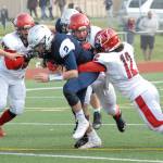 Eagle River&rsquo;s Ryan Adkins is tackled by several Kenai players during the Kardinals&rsquo; 42-28 Northern Lights Conference football win over the Wolves on Saturday, Sept. 2, 2017 at Eagle River High School. (Star photo by Matt Tunseth)