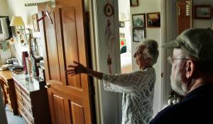 Joanna Hollier (left) shows visitor Gary Sonnevil around her apartment in Kenai's Vintage Pointe Manor during an open house in honor of the senior housing center's 25 anniversary on Thursday, September 7, 2017 in Kenai, Alaska. Hollier moved into the 40-unit housing complex immediately after it opened in 1992 — at the age of 67, "so I was pretty young back then," she said — and is its only remaining original resident. At the anniversary celebration, Hollier, who came to Kenai in the mid-1940s to work as an air traffic controller at the city's airport, recalled how she'd waited in line to get her room after the center opened and moved her furniture from her homestead house on Beaver Loop Road. Also attending the celebration were former Kenai mayor Pat Porter — who was director of the Kenai Senior Center in 1992 and is visiting from her current home in Texas &nbsp;— then-Kenai Mayor John Williams and Kenai's then-state senator Paul Fischer. Porter, Williams, and Fischer recalled how the city had lobbyed the Alaska legislature for funds to build Vintage Pointe, including baking cookies for the Senate Finance Committee and distributing a photo of a senior woman in a bed outside during a snowy winter, holding a sign reading "Don't leave us out in the cold." (Photo by Ben Boettger/Peninsula Clarion)