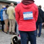 A participant in Sunday&rsquo;s Out of the Darkness Kenai Walk adorned a bib saying who she was walking for &mdash; Mason Vig and too many students. The walk started at the Kenaitze Fishery Site in Kenai, Alaska and continued down the beach for one mile. (Photo by Kat Sorensen/Peninsula Clarion)