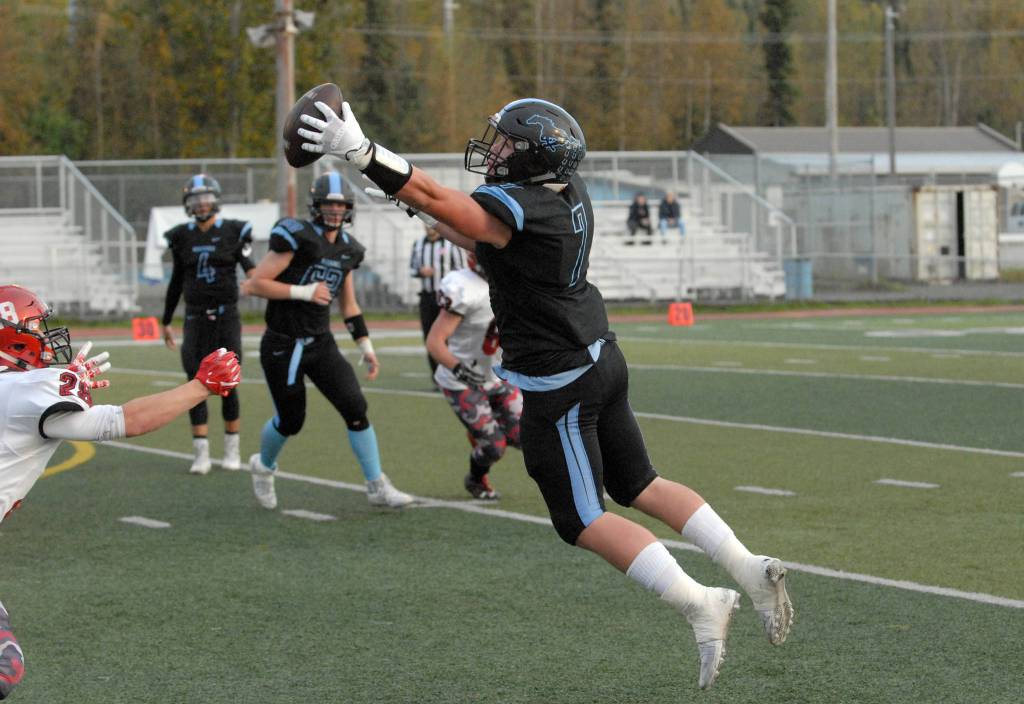 Chugiak&rsquo;s Derryk Snell leaps to catch a pass during Chugiak&rsquo;s 48-0 nonconference high school football win over Kenai on Friday, Sept. 15, 2017 at Tom Huffer Sr. Stadium in Chugiak. (Star photo by Matt Tunseth)