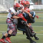 A host of Kenai tacklers takes down Chugiak&rsquo;s Austin Harr during Chugiak&rsquo;s 48-0 nonconference high school football win over Kenai on Friday, Sept. 15, 2017 at Tom Huffer Sr. Stadium in Chugiak. (Star photo by Matt Tunseth)