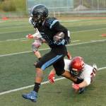 Chugiak&rsquo;s Ramal Maad tries to break free of Kenai Central&rsquo;s Rykker Riddall during Chugiak&rsquo;s 48-0 nonconference high school football win over Kenai on Friday, Sept. 15, 2017 at Tom Huffer Sr. Stadium in Chugiak. (Star photo by Matt Tunseth)