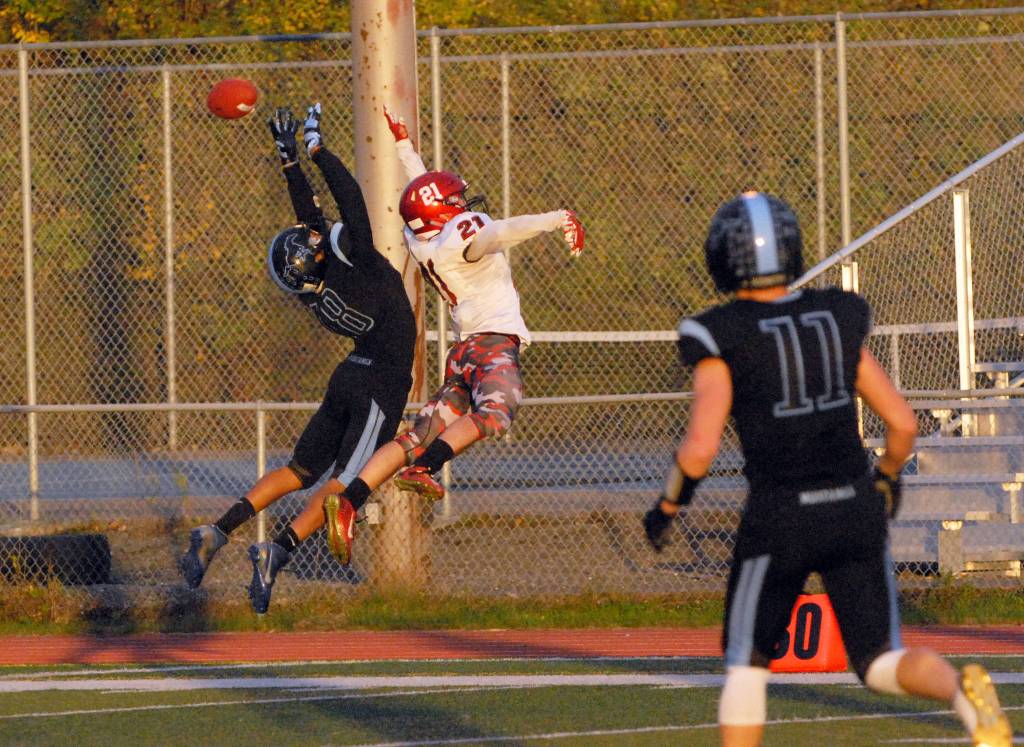 Chugiak defensive back Ramal Maad, left, and Kenai Central wide receiver Zack Tuttle go up for a pass during Chugiak&rsquo;s 48-0 nonconference high school football win over Kenai on Friday, Sept. 15, 2017 at Tom Huffer Sr. Stadium in Chugiak. (Star photo by Matt Tunseth)