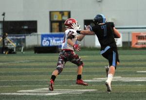 Chugiak&rsquo;s Derryk Snell stiffarms Kenai Central&rsquo;s Titus Riddall during Chugiak&rsquo;s 48-0 nonconference high school football win over Kenai on Friday, Sept. 15, 2017 at Tom Huffer Sr. Stadium in Chugiak. (Star photo by Matt Tunseth)