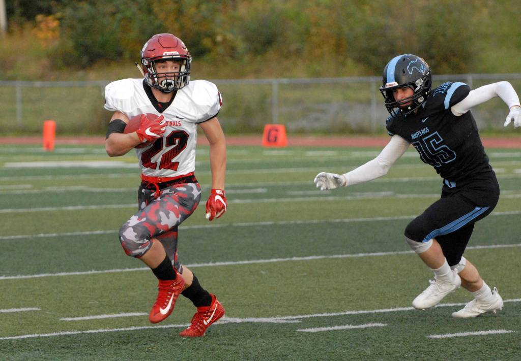 Kenai Central&rsquo;s Titus Riddall tries to escape Chugiak&rsquo;s Jacob Oshesky during Chugiak&rsquo;s 48-0 nonconference high school football win over Kenai on Friday, Sept. 15, 2017 at Tom Huffer Sr. Stadium in Chugiak. (Star photo by Matt Tunseth)