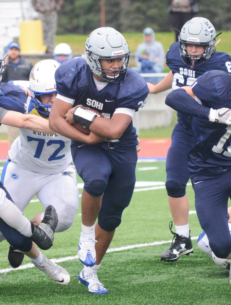 Soldotna running back Aaron Faletoi cuts through a hole in the Kodiak defense Saturday at Justin Maile Field in Soldotna. (Photo by Joey Klecka/Peninsula Clarion)