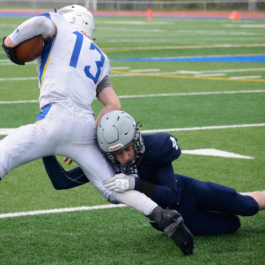 Soldotna defensive back Jersey Truesdell goes in for a tackle on Kodiak running back Kaleb Finley (13) Saturday at Justin Maile Field in Soldotna. (Photo by Joey Klecka/Peninsula Clarion)