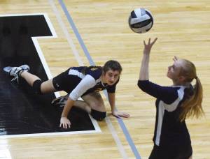 Homer sophomore Marina Carroll watches as teammate Kelli Bishop sends the ball into Nikiski&rsquo;s court Tuesday night at Nikiski High School. (Photo by Joey Klecka/Peninsula Clarion)