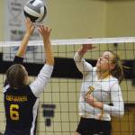 Nikiski junior Bethany Carstens jumps up to block a shot by Homer&rsquo;s Karmyn Gallios Tuesday night at Nikiski High School. (Photo by Joey Klecka/Peninsula Clarion)