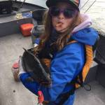 Lily Craig shows off the silver salmon she caught on the Kenai River during the Kenai Chamber of Commerce&rsquo;s first annual silver salmon derby in September 2017. (Photo courtesy Nathaniel Craig)