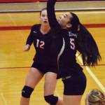 Kenai Central&rsquo;s Kailey Hamilton (12) watches as teammate Nikki Prior sends the ball at Kodiak&rsquo;s court Thursday at Kenai Central High School. (Photo by Joey Klecka/Peninsula Clarion)