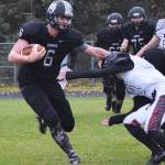 Nikiski junior Cody Handley (6) stiff arms Eielson defender Jeremiah Brown Friday evening at Nikiski High School. (Photo by Joey Klecka/Peninsula Clarion)