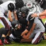 Nikiski senior Ian Johnson (middle) is tackled by a host of Eielson players Friday evening at Nikiski High School. (Photo by Joey Klecka/Peninsula Clarion)