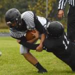 Eielson junior Jaydenn Manibusan attempts to shed Nikiski tackler Tyler Olson Friday evening at Nikiski High School. (Photo by Joey Klecka/Peninsula Clarion)