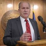 FILE - In this June 16, 2017, file photo Alaska Gov. Bill Walker speaks to reporters after calling a second special legislative session in Juneau, Alaska. Walker limited the session agenda to the state operating budget. Gov. Walker will propose a head tax on Alaskans to partially fill the multi-billion dollar gap between state revenue and spending. The governor, an independent, at special legislative session next month will propose a 1.5 percent flat tax on wages or self-employment income. (AP Photo/Becky Bohrer, File)