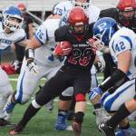 Kenai Central senior Rykker Riddall (28) works through a throng of Palmer tacklers Saturday at Ed Hollier field in Kenai. (Photo by Joey Klecka/Peninsula Clarion)