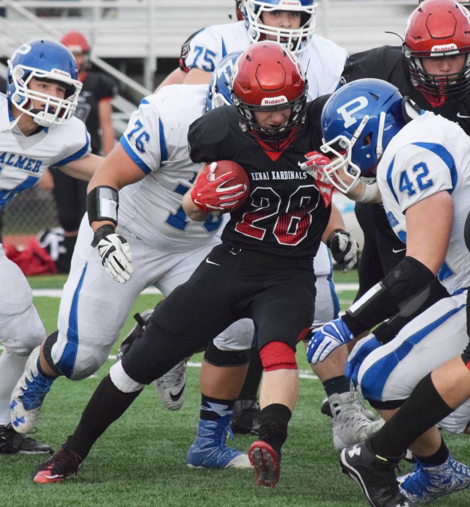 Kenai Central senior Rykker Riddall (28) works through a throng of Palmer tacklers Saturday at Ed Hollier field in Kenai. (Photo by Joey Klecka/Peninsula Clarion)