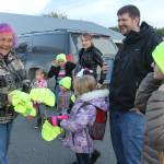 Event organizer Sharon Hale hands out Safe Kids easy to be seen hats on Walk to School day.