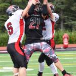 Kenai Central senior Zack Tuttle (21) reaches up to grab a pass against Juneau, Aug. 26 at Ed Hollier Field in Kenai. (Photo by Joey Klecka/Peninsula Clarion)