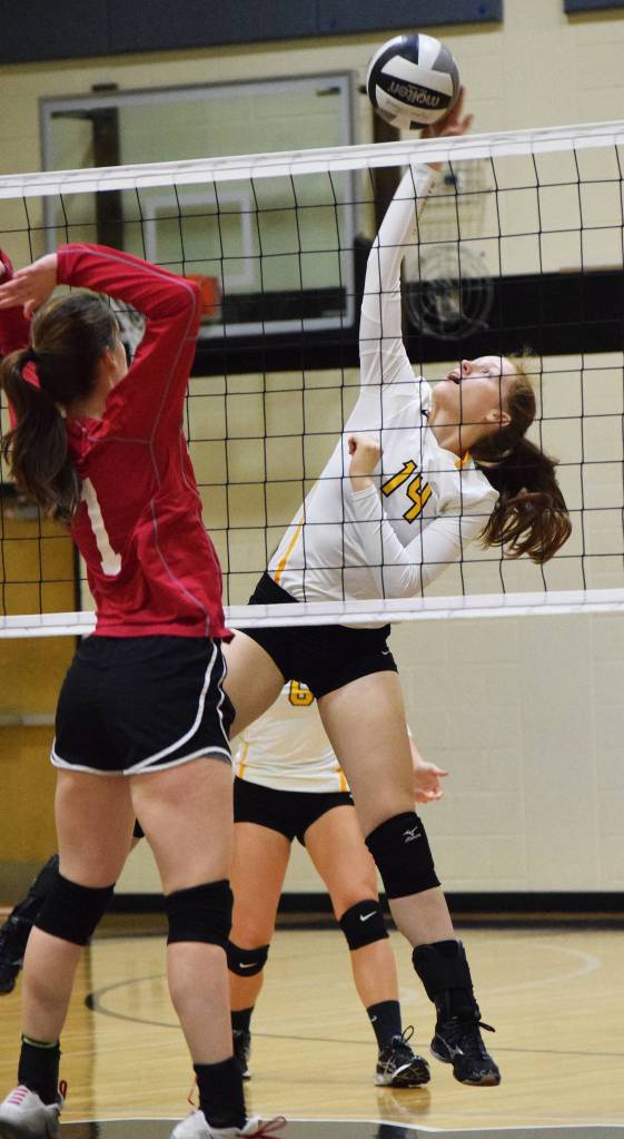 Nikiski sophomore Kaycee Bostic tips a pass from Anchorage Christian middle hitter Mary Kate Parks (1) Friday at Nikiski High School. (Photo by Joey Klecka/Peninsula Clarion) Nikiski sophomore Kaycee Bostic tips a pass from Anchorage Christian middle hitter Mary Kate Parks (1) Friday at Nikiski High School. (Photo by Joey Klecka/Peninsula Clarion)
