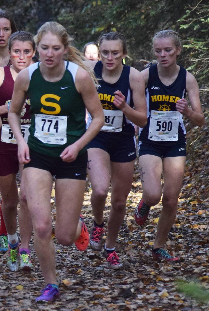 Seward senior Ruby Lindquist (774) leads a pack of Division II girls runners up the hill with eventual race winner Autumn Daigle (middle) of Homer in tow Saturday at the ASAA First National Bank Alaska Cross-country State Championships at Bartlett High School. (Photo by Joey Klecka/Peninsula Clarion)