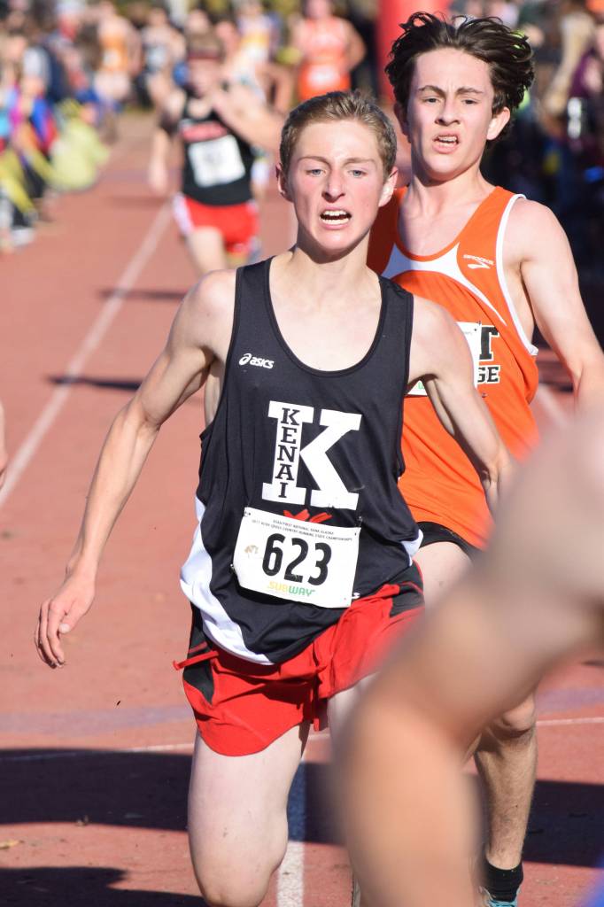 Kenai Central freshman Maison Dunham beats out a cluster of racers in the Division I boys race Saturday at the ASAA First National Bank Alaska Cross-country State Championships at Bartlett High School. (Photo by Joey Klecka/Peninsula Clarion)
